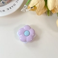 Detailed top view of purple flower phone grip with blue center and smooth glossy surface - Purple