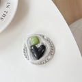 Detail of a butterfly heart phone socket with green gem and pearl rhinestone inlay - Smudge Black Heart (Rhinestone/Magnetic)