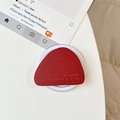 Close-up of red lychee leather triangle phone socket with premium stitching and base - Burgundy