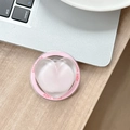 Detail of a pink heart-shaped phone grip with Good Luck text on a wooden desk near a laptop - Magnetic Sandwich Heart / Pink