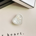 Close-up of heart-shaped pearls and butterfly inside a resin mobile phone grip stand - Adhesive Stand - Pearlescent Butterfly - White