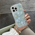 Blue glitter iPhone case with 3D resin bows and pearl flower decorations in hand - Blue Glitter Plum Blossom Bow Style / iPhone 7/8/SE 2020