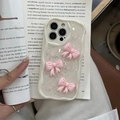 Glittery iPhone case with pink 3D bows and wave edges on an open vintage book - Macaron Bow - Cream White (Cream Shell Laser Sequin Drip Glue) / iPhone 16plus