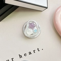 Detail of a pearl shell heart grip tok with star and blue heart charms on a leather surface - Magnetic Cat-Eye Starfish (Purple)