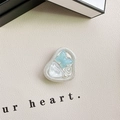 Macro shot of heart-shaped phone grip with blue butterfly and pearl accents on leather - Adhesive Stand - Pearlescent Butterfly - Blue