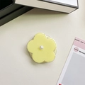 Detail view of yellow flower phone grip with white pearl on a cream textured surface - Jelly Magnetic / Pearl Yellow Flower