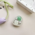 Detail of shell phone grip featuring green stone and white pearl on leather surface - Adhesive Stand Cat-Eye Shell (Green)