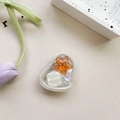 Macro detail of transparent resin phone grip with colorful star and heart glitter accents - Adhesive Stand Cat-Eye Starfish (Orange)