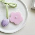 Detailed view of a pink flower phone grip with a white pearl center on a textured tray - Transparent Stand / Pearl Pink Flower
