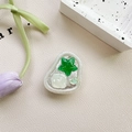 Detail of a resin phone grip with green stars and heart elements on leather background - Adhesive Stand Cat-Eye Starfish (Green)
