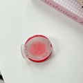 Detail of cute fish-shaped phone stand with smiley face pattern on frosted clear cover - Red