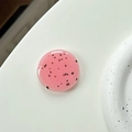 Detail of pink resin phone grip with black spots resembling dragon fruit texture - Coral Pink