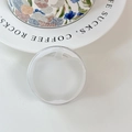 Close-up of apple shaped frosted white magnetic phone grip stand on a white table - (Dopamine) Magnetic-Sandwich Apple-White