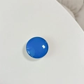Detail of glossy blue crystal glass pop socket with a high-shine reflective finish - White Stand / Royal Blue