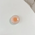 Macro shot of circular phone socket with pink orange gradient and high gloss finish - White Stand / Orange Dots