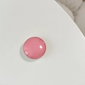 Close-up of a glossy pink round crystal glass telescopic phone socket on a white surface - Bean Paste Red