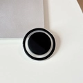 Close-up of minimalist black and silver magnetic folding phone grip with metallic frame - Black