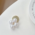 Close-up of four high-gloss pearls on a golden base showing elegant texture and detail - Gold Large Pearl Style