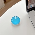 Close-up of a blue crystal glass telescopic phone socket on a white desk - Lake Blue