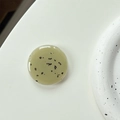 Detail of green resin phone grip with black stone fragments and smooth glossy finish - Dark Green