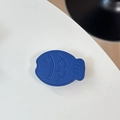 Makroaufnahme des dunkelblauen Fisch-Handyhalters aus Leder mit feiner Narbung und Nähten - Leder Taiyaki / Königsblau
