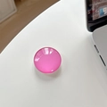 Macro shot of rose pink round crystal glass phone grip on a white desk with laptop background - Rose Red