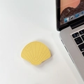 Detail of yellow shell-shaped leather phone stand with fine stitching on a white desk - Leather Shell-Yellow