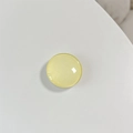 Macro detail of round translucent yellow crystal glass phone stand surface and glossy finish - Light Yellow