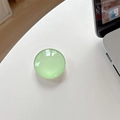 Detailed view of a light green crystal glass circular expandable phone socket grip - Light Green