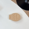 Close-up of khaki leather fish phone socket with detailed stitching and embossed fish design - Leather Taiyaki / Khaki