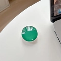 Detail of a deep emerald green crystal glass phone grip showing high-gloss mirror finish - Cyan Green