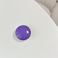 Close-up of a purple crystal glass round cell phone socket stand on a white surface - Dark Purple