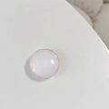 Macro detail of a round pink gradient crystal glass phone grip with a polished glossy finish - Marble Pink Edge