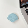 Macro shot of light blue shell-shaped leather phone grip with detailed stitching on desk - Leather Shell-Light Blue