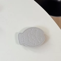 Detail of silver fish-shaped leather phone grip with lychee texture and stitching - Leather Taiyaki / Silver