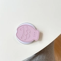 Close-up of pink faux leather taiyaki fish phone socket with textured scales and round base - Purple