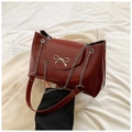 Elegant burgundy tote bag with silver chain and bow detail, trapezoidal fashion purse - Red