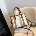 Chic striped canvas tote bag with brown leather handles and adjustable shoulder strap - Off White