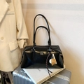 Glossy black leather bowling bag with long shoulder straps and baseball charm detail - Black With Pendant