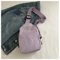 Macro detail of lavender nylon chest bag with pleated texture and metal 'M' logo - Purple