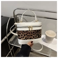Detail of leopard print bucket bag with contrast stitching and golden zipper closure - White