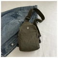 Detail of army green nylon chest bag with metallic M logo and durable zipper pocket - Green