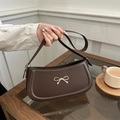 Deep brown leather underarm bag with gold bow ornament and slim shoulder strap - Brown