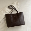 Deep brown oil wax leather tote bag for women shown with stylish white jacket - Dark Brown
