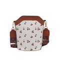 White bucket bag with red cherry pattern and colorful geometric woven strap for women - Brown