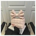 Close-up of pink quilted cloud bag featuring a large decorative bow and soft padded texture - Pink