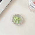 Close-up of light green leather phone grip with crystal rhinestones and a 3D bow - Green