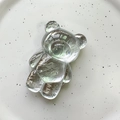 Macro detail of clear resin bear-shaped phone grip with a glossy crystal finish - Bear / Tin Foil Pattern