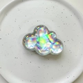 Close-up of holographic cloud phone socket with iridescent finish on a ceramic plate - Cloud / Silver Laser