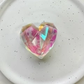 Detailed macro view of a heart-shaped laser crystal phone grip with pink glitter accents - Geometric Heart (Large) / Holographic Multicolor